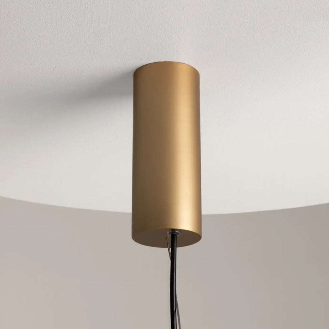 Suspension enigma cylindre en métal doré mat avec cordon noir et orientation réglable pour éclairage led moderne