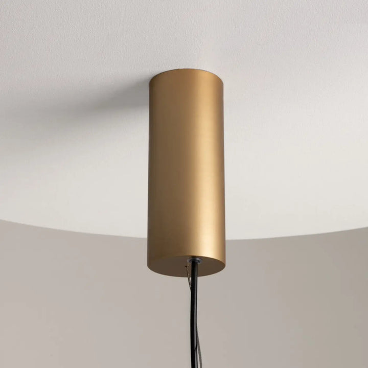 Suspension enigma cylindre en métal doré mat avec cordon noir et orientation réglable pour éclairage led moderne
