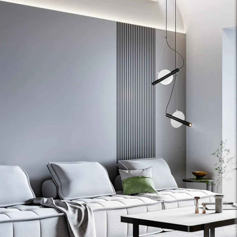 Suspension enigma cylindre en noir et blanc avec design minimaliste et orientation réglable au-dessus du sofa