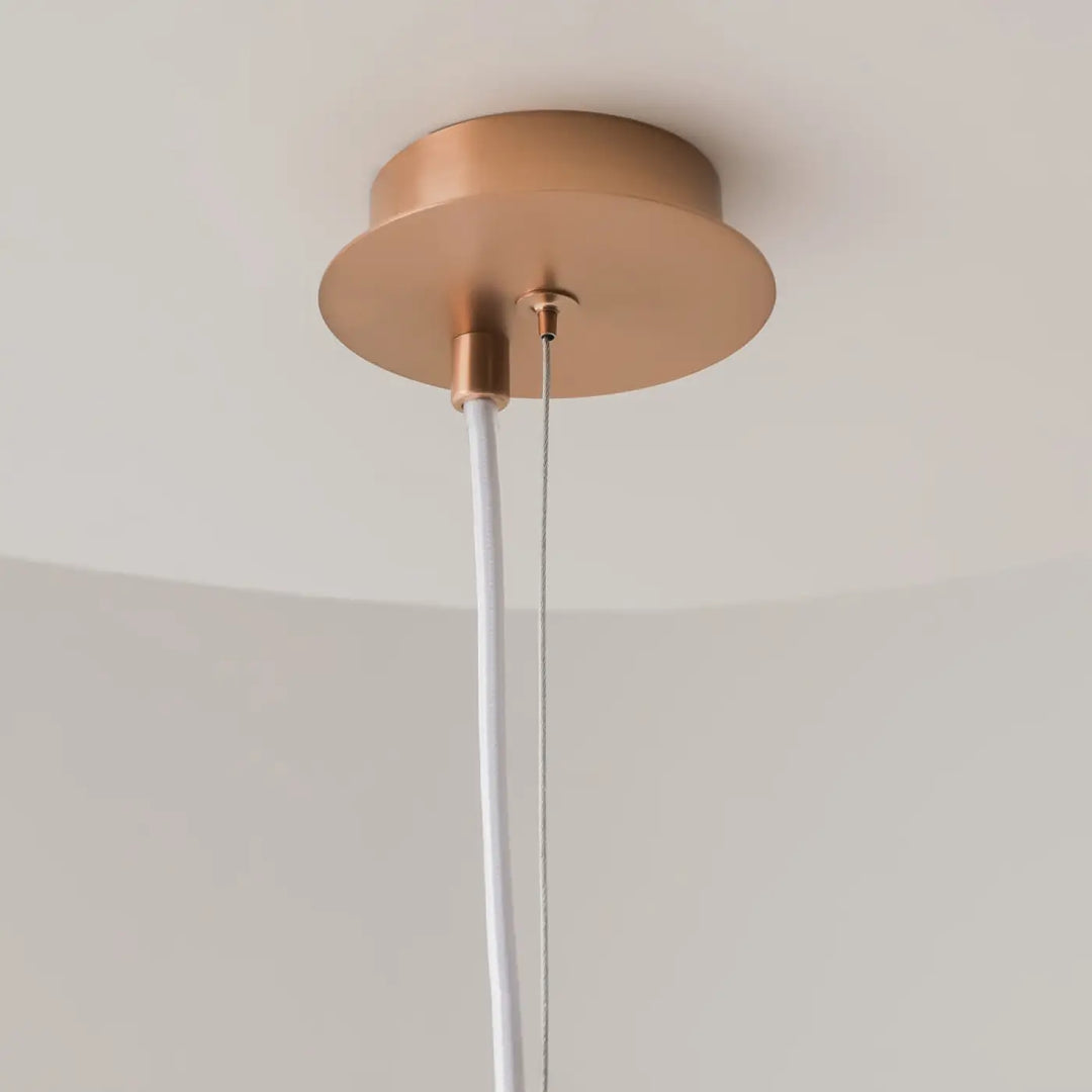 Suspension luminaire erich globe cuivre avec base circulaire minimaliste et lumière douce pour style art déco verre soufflé