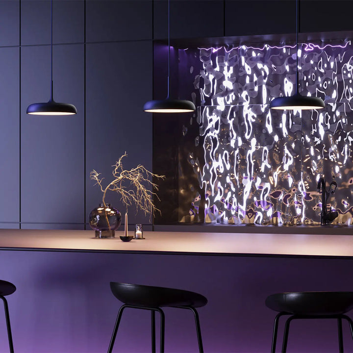 Trois suspension gerhard noires avec led intégrée et coupole arrondie suspendues au-dessus dîlot de cuisine moderne