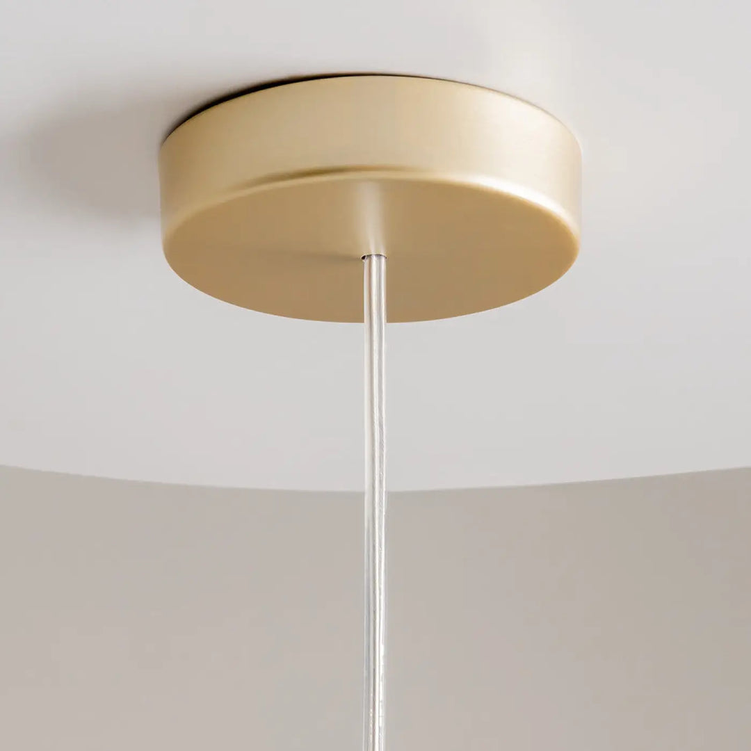 Suspension kyoto cylindre en acier noir avec montage plafond circulaire doré et câble transparent pour lumière douce