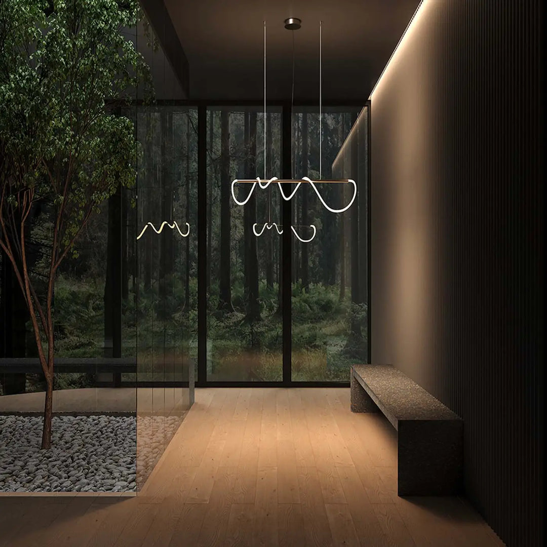Suspension led tau ruban souple art déco avec courbes led blanches suspendue au-dessus d’une pièce moderne