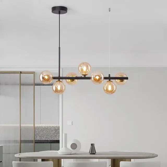 Suspension luminaire à boules de verre teinté sur un support noir

