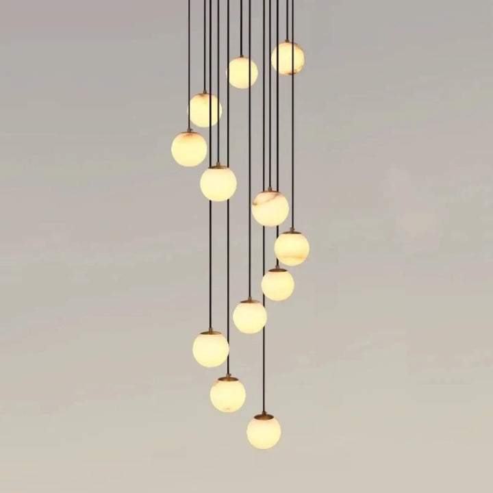 Suspension luminaire souble avec suspension design boules en verre marbré chic couleur crème chaude style univers art déco