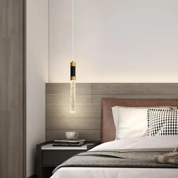 Suspension luminaire kairo avec design cylindrique, embouts métalliques dorés, tube en verre à effet bulles étincelantes led