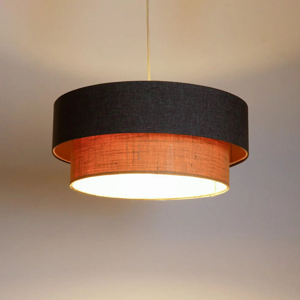 Suspension luminaire duo boho elegant marron gris avec double abat-jour texturé noir et anneau tissé orange émettant une lumière chaude