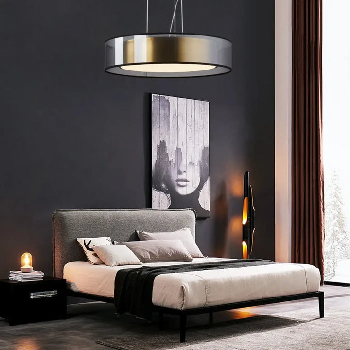 Modern suspension luminaire kylos with a round pendant light featuring metallic gold and silver finish