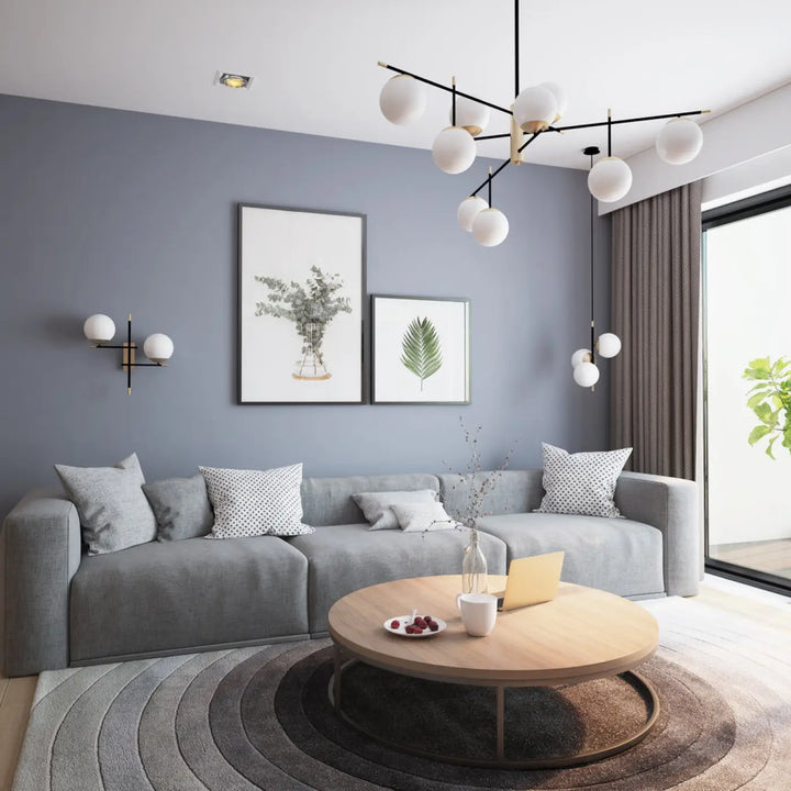 Suspension luminaire nostalgia xxl en acier noir avec un canapé dangle gris et coussins à motifs neuf globes