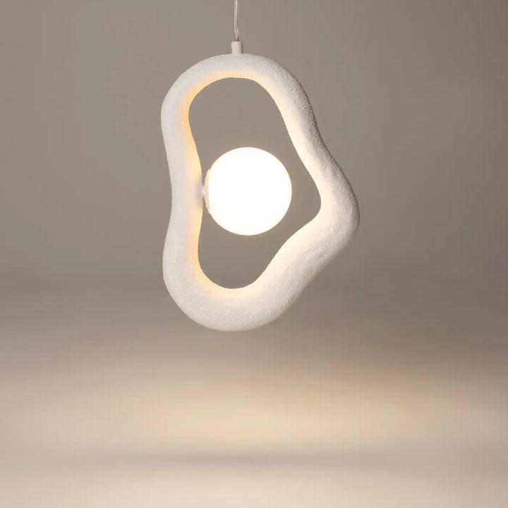 Suspension opus blanche en volume irrégulier avec lumière douce et texture rappelant un œuf au plat éclairé au centre