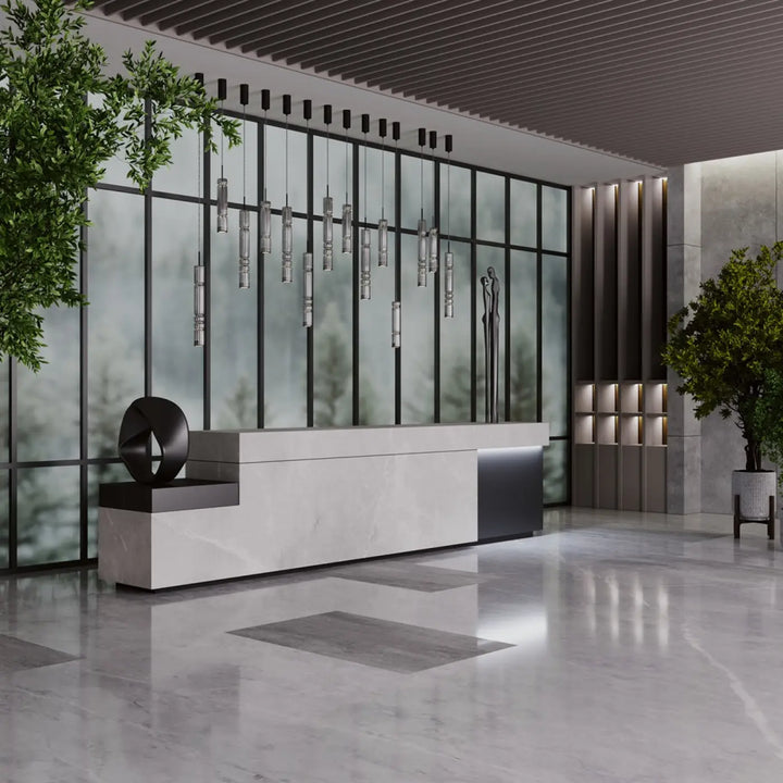 Modern white marble reception desk with sleek black accents featured under suspension ordo led verre teinté lighting tube