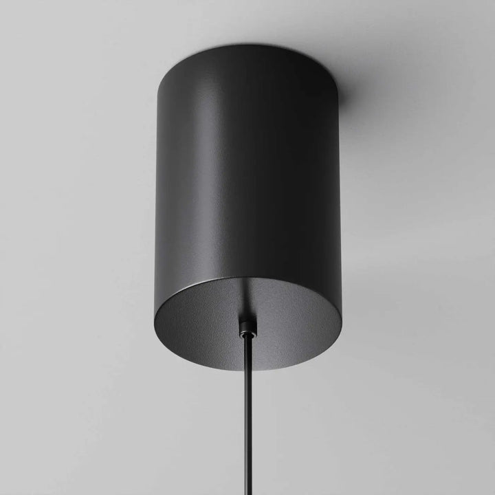 Suspension plato disque vertical en métal noir mat avec design cylindrique minimaliste pour éclairage intérieur