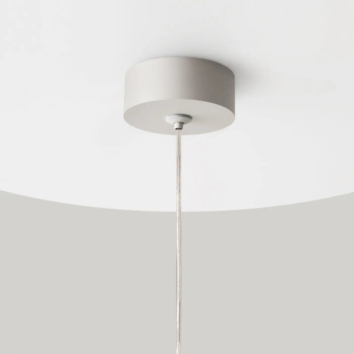 Luminaire suspension polar petit disque avec suspension cylindrique blanche minimaliste et câble métallique fin
