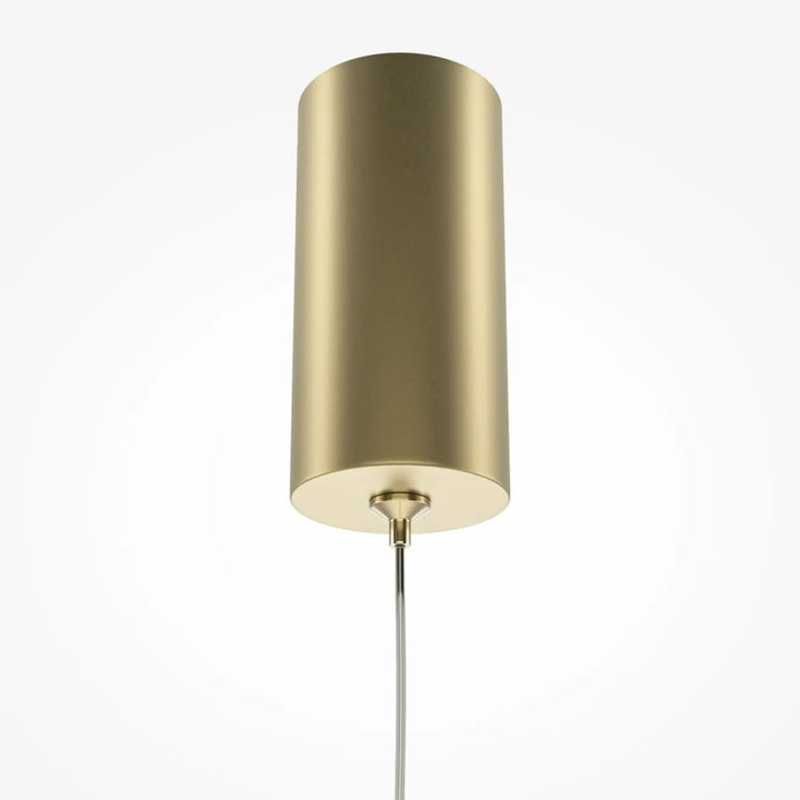 Suspension pro tube lumineux en laiton cylindrique au design minimaliste avec finition métallique polie au-dessus d’un espace