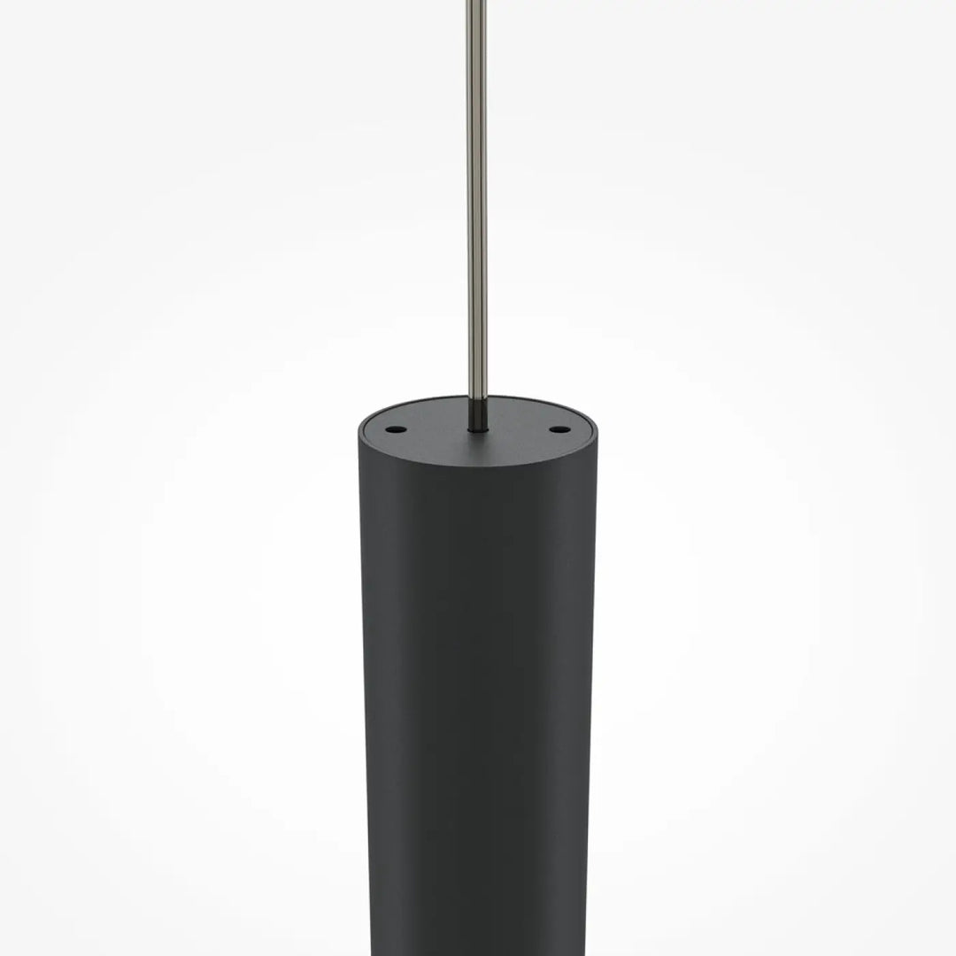 Suspension pro tube lumineux en cylindre noir mat avec tige métallique fine au-dessus d’un espace moderne