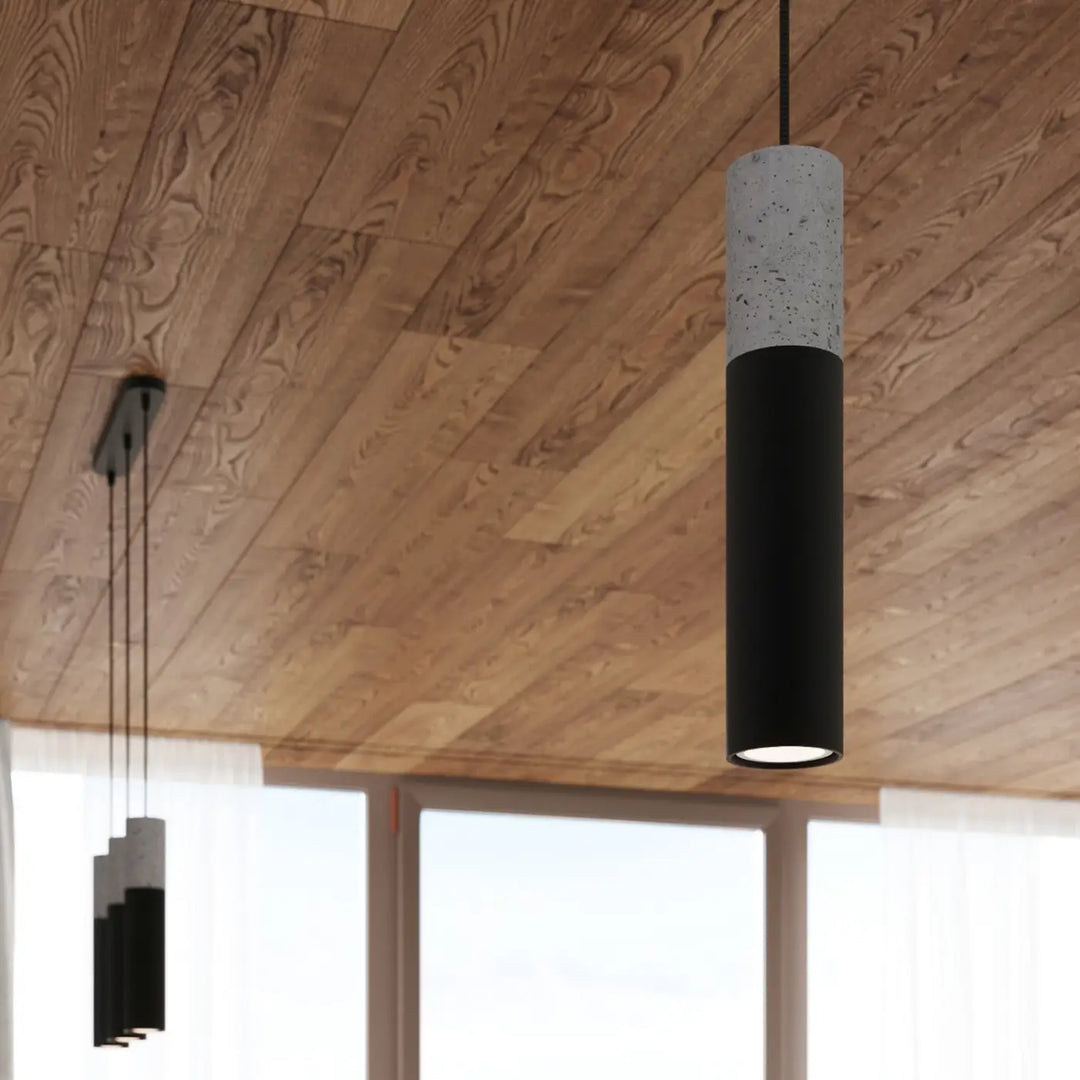 Suspension Borgio tube en acier noir et béton gris dans un intérieur contemporain